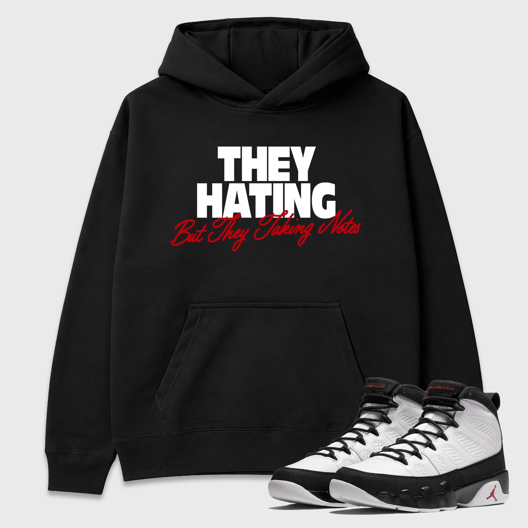 They Hating But Taking Notes Graphic T-Shirt featuring original streetwear artwork designed to match the Air Jordan 9 True Red. Black 1 Graphic Tee.