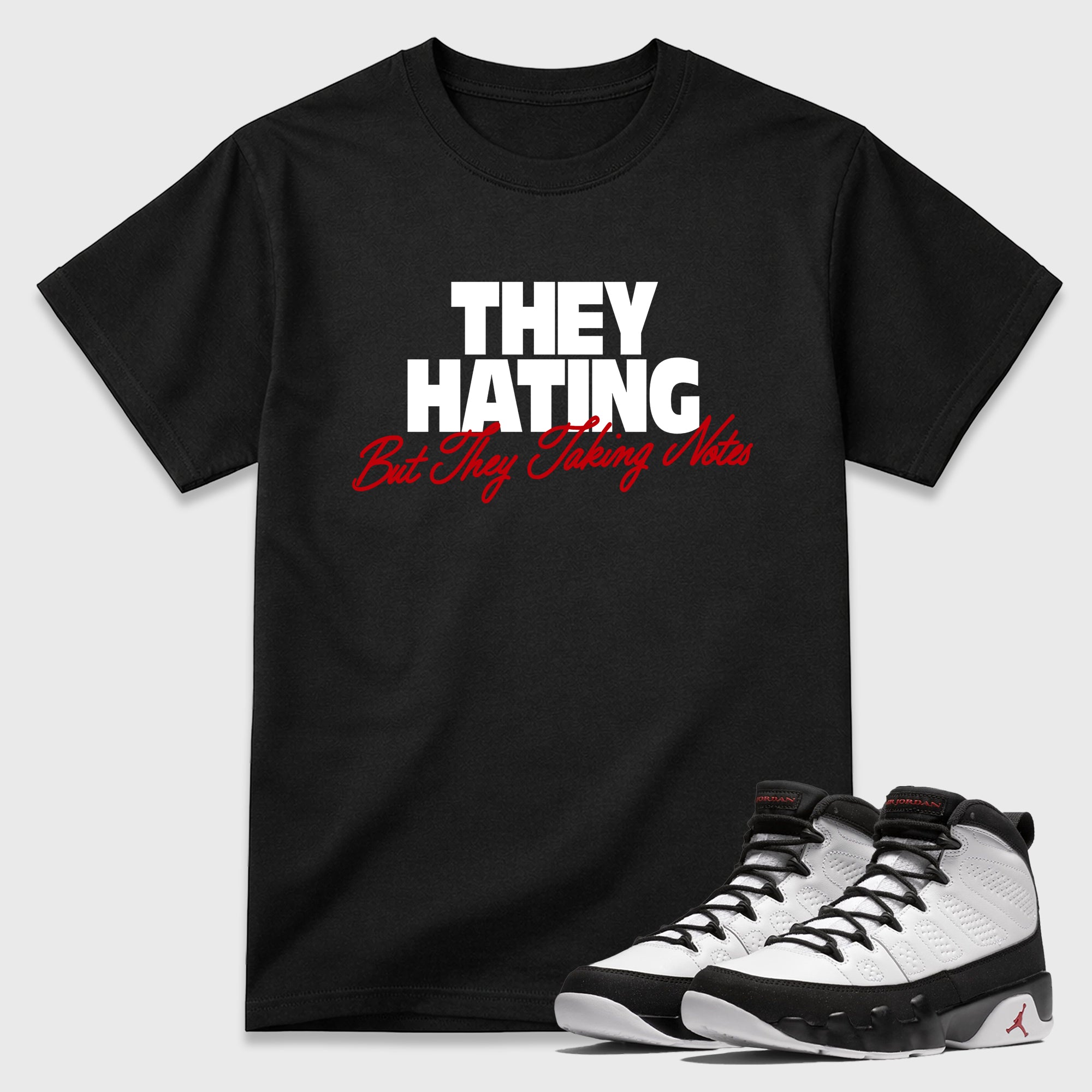 They Hating But Taking Notes Graphic T-Shirt featuring original streetwear artwork designed to match the Air Jordan 9 True Red. Black 1 Graphic T-Shirt.