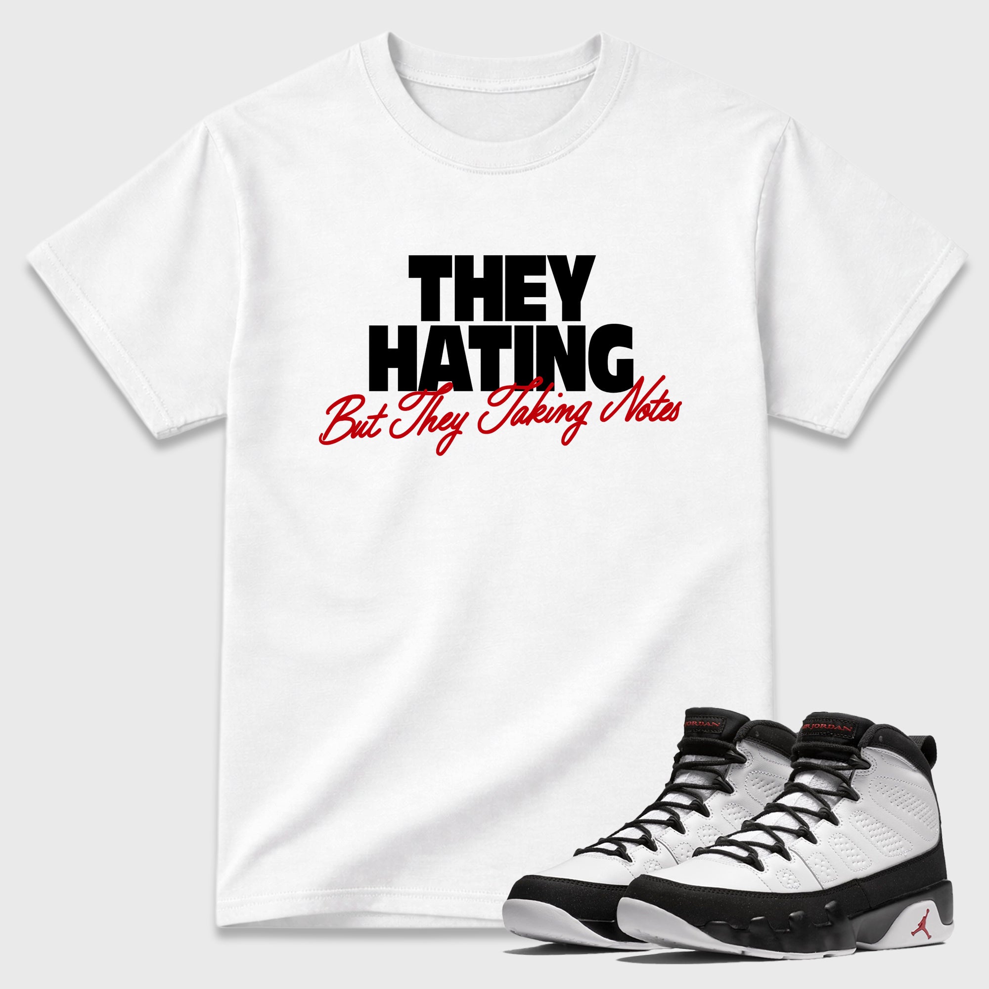They Hating But Taking Notes Graphic T-Shirt featuring original streetwear artwork designed to match the Air Jordan 9 True Red. White 1 Graphic T-Shirt.