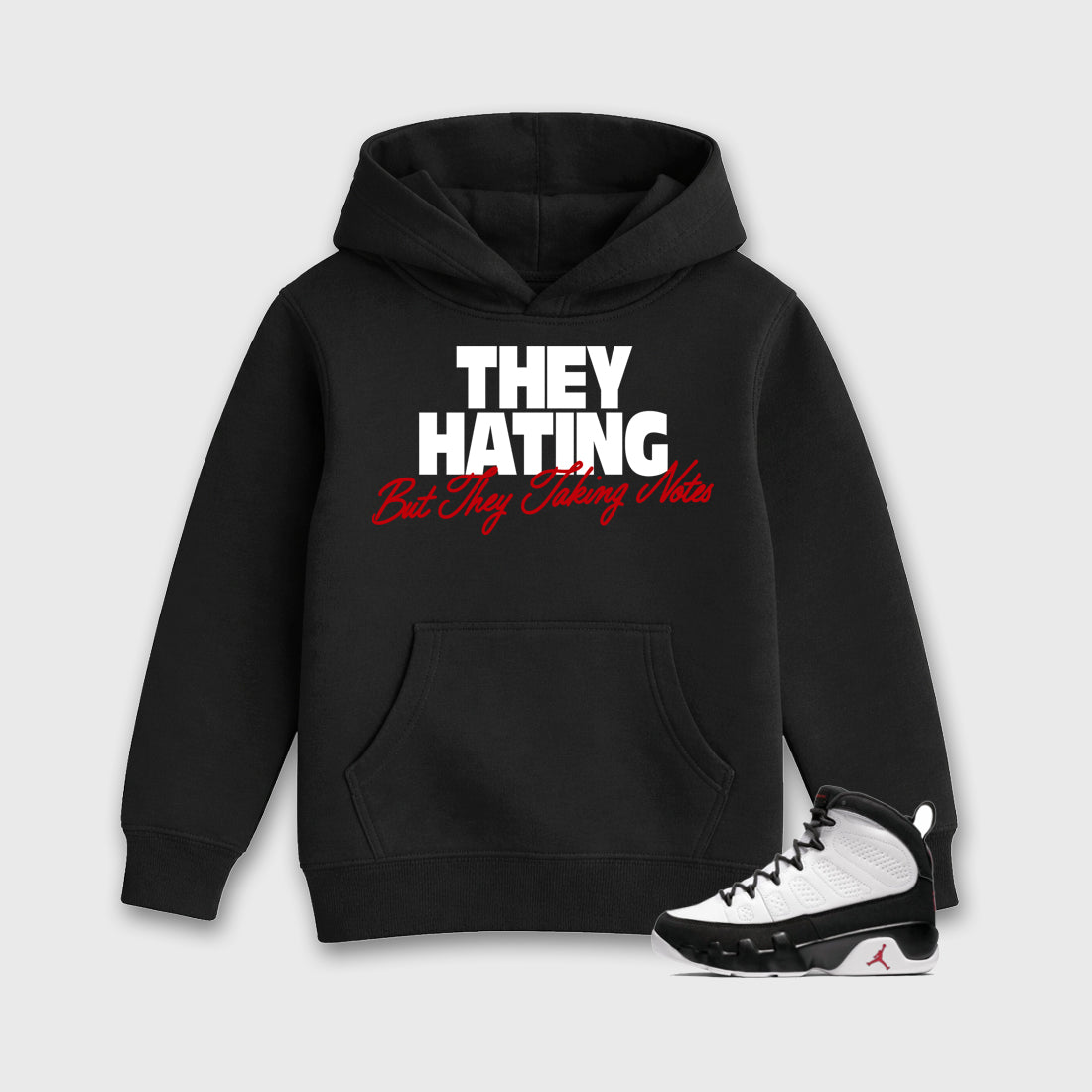 They Hating But Taking Notes Baby & Kids Graphic Hoodie featuring original artwork designed to match the Air Jordan 9 True Red. Black 1 Kids Graphic Sweater.