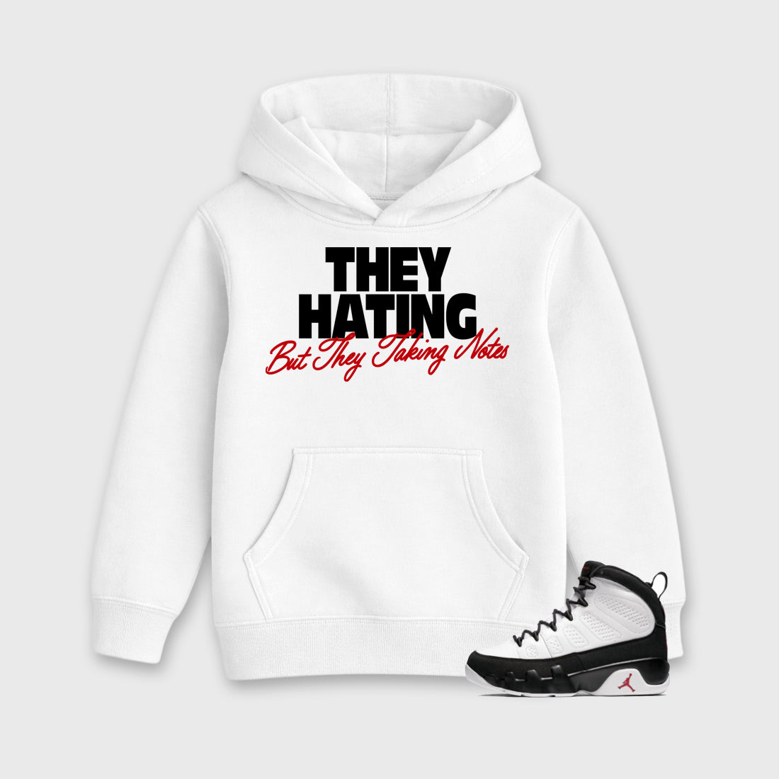 They Hating But Taking Notes Baby & Kids Graphic Hoodie featuring original artwork designed to match the Air Jordan 9 True Red. White 1 Kids Graphic Sweater.