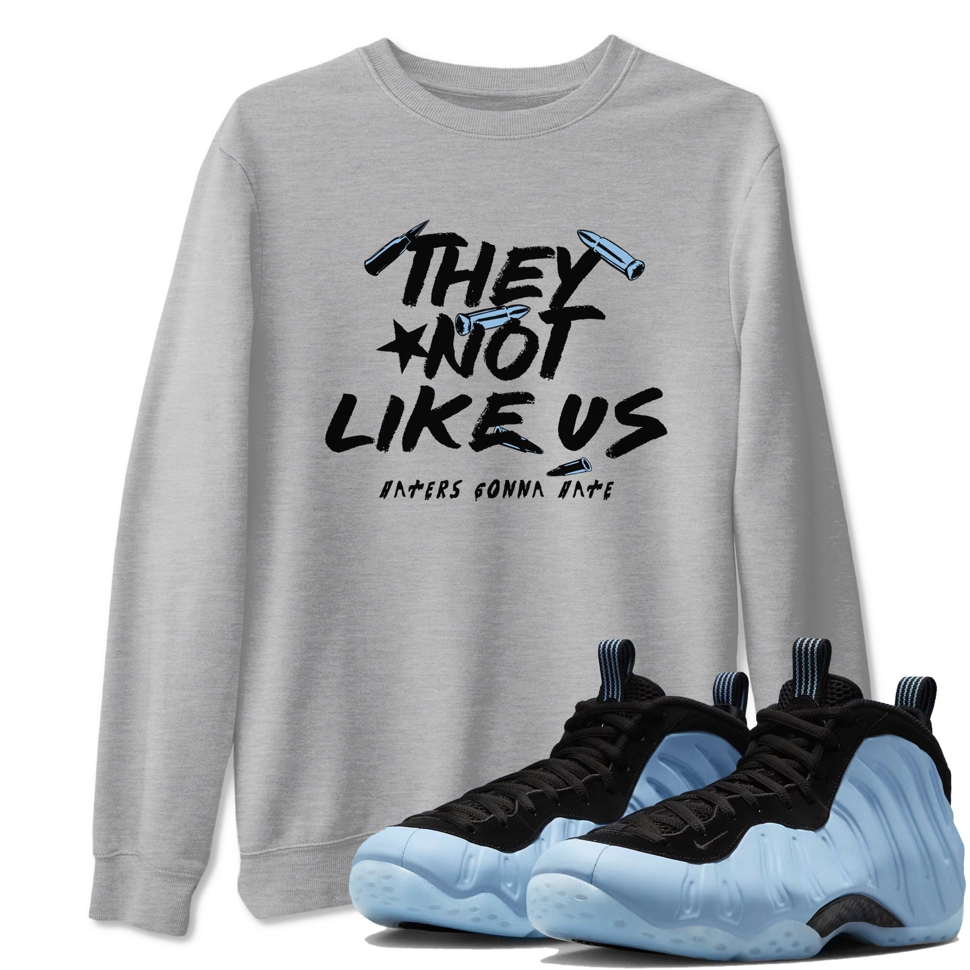 They Not Like Us sneaker match t-shirt styled to complete your fit with the Air Foamposite One Psychic Blue sneakers, shown in Heather Grey 1.