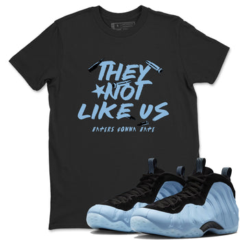 They Not Like Us sneaker match t-shirt styled to complete your fit with the Air Foamposite One Psychic Blue sneakers, shown in Black 1.
