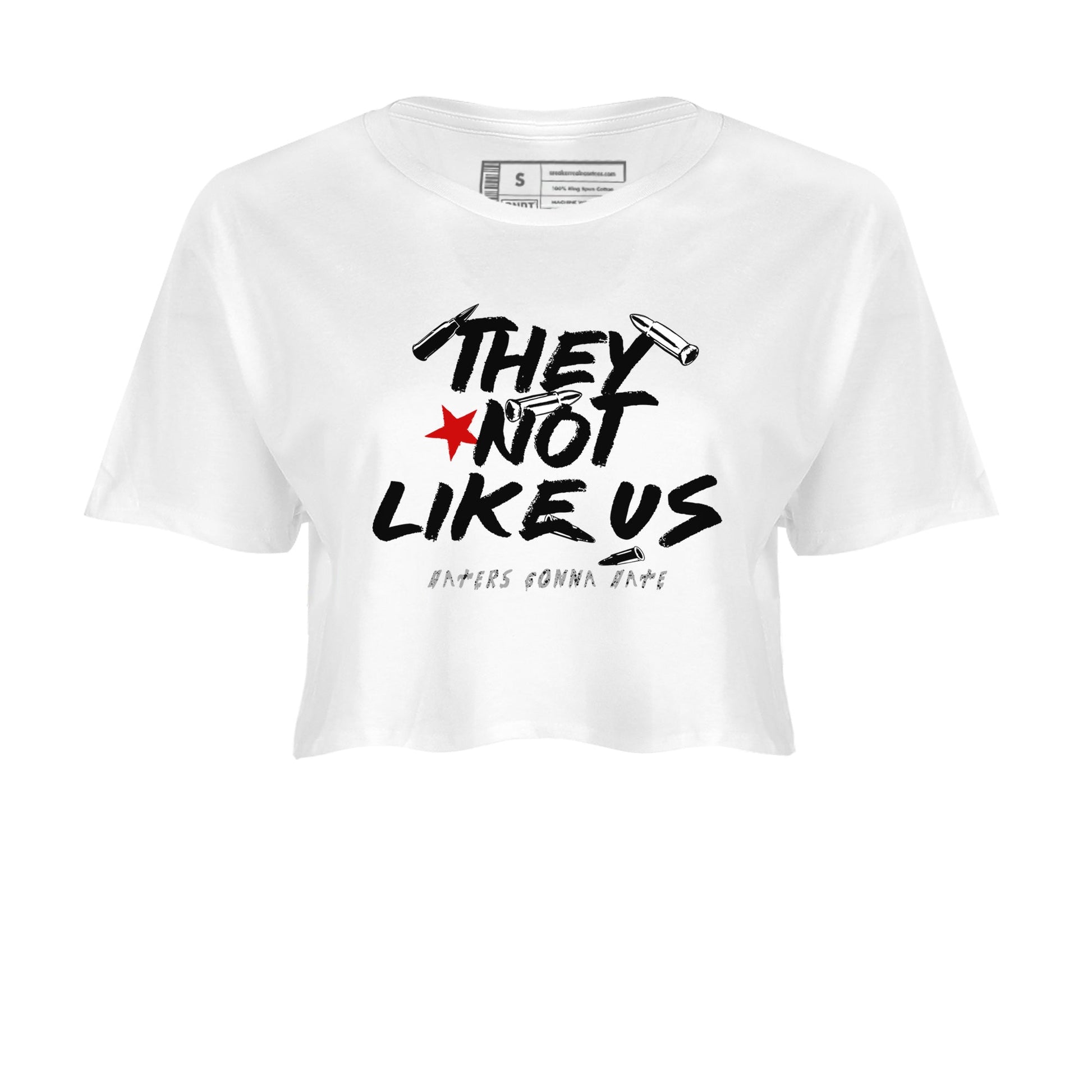They Not Like Us womens crop tee made to vibe with the Air Jordan 4 White Cement sneakers — the perfect match in White 2.