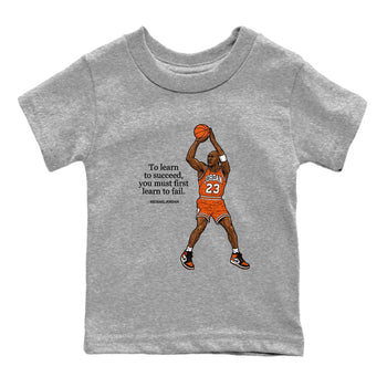 Michael Jordan Quotes To Learn To Succeed You Must First Learn To Fail baby and kids t-shirt crafted for little sneakerheads to shine with the Air Jordan 1 Shattered Backboard sneakers, displayed in Heather Grey 2.