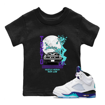 Tokyo Drift baby and kids t-shirt crafted for little sneakerheads to shine with the Air Jordan 5 Grape sneakers, displayed in Black 1.