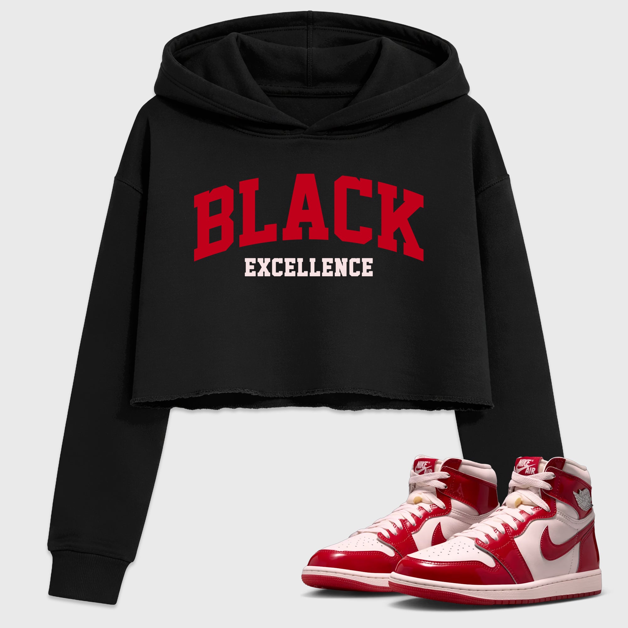 Varsity Black Excellence Women’s Graphic Crop Tee featuring original streetwear artwork designed to match the Air Jordan 1 Nails and Grails. Black 1 Crop Tee.