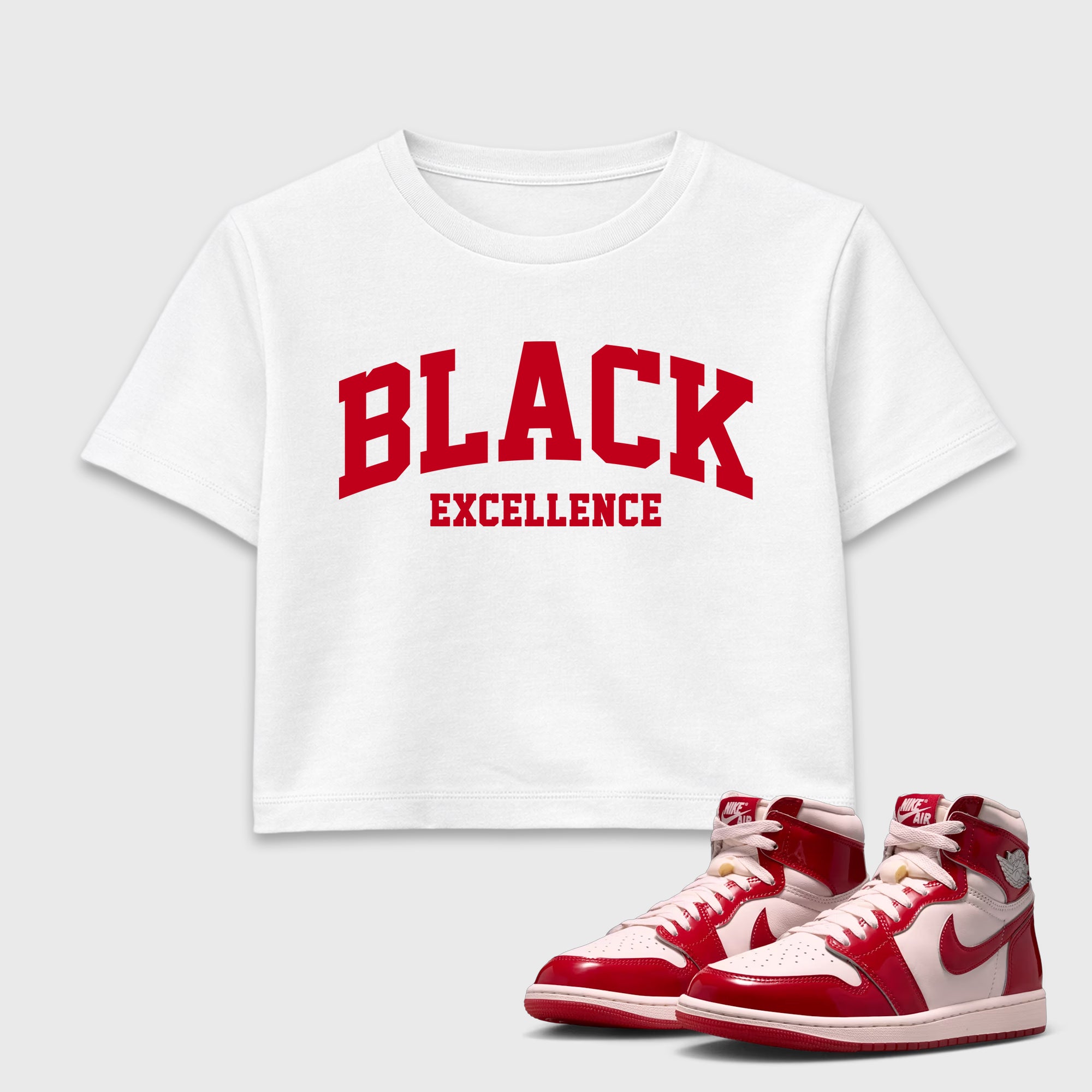 Varsity Black Excellence women’s crop tee designed to match the Air Jordan 1 Nails and Grails, featuring coordinated White 1 options for a perfect streetwear vibe.