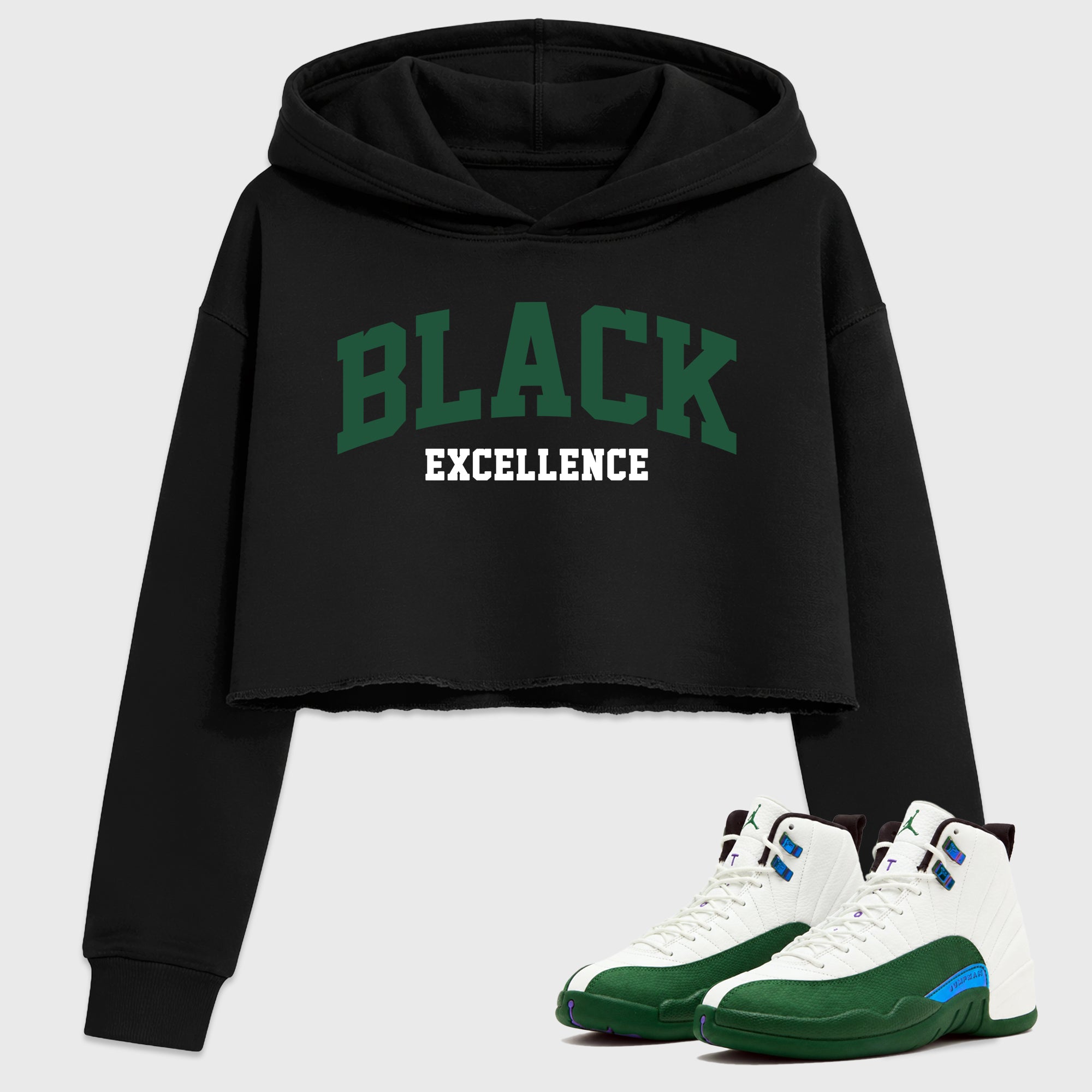 Varsity Black Excellence Women’s Graphic Crop Tee featuring original streetwear artwork designed to match the Air Jordan 12 Summit Green. Black 1 Crop Tee.
