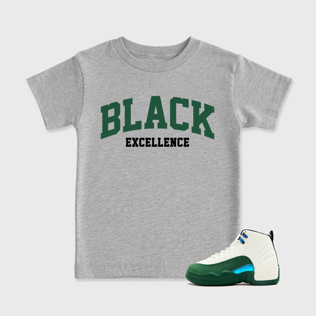 Varsity Black Excellence Baby & Kids Graphic T-Shirt featuring original artwork designed to match the Air Jordan 12 Summit Green. Heather Grey 1 Kids Graphic Tee.
