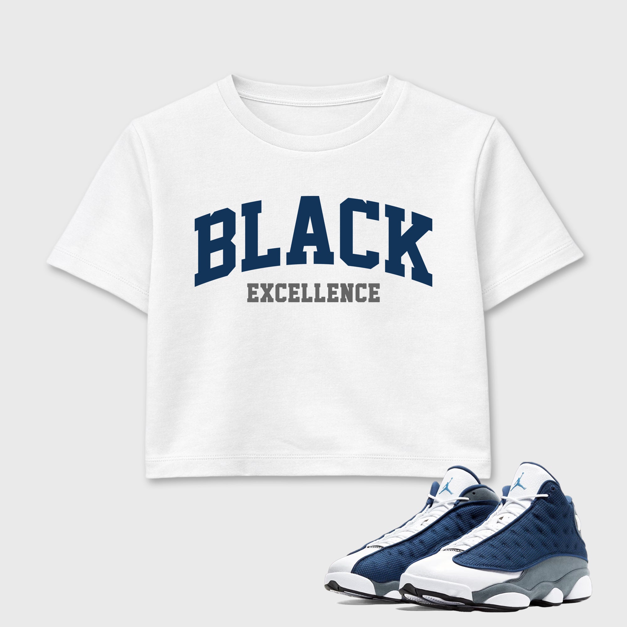 Varsity Black Excellence women’s crop tee designed to match the Air Jordan 13 Flint, featuring coordinated White 1 options for a perfect streetwear vibe.