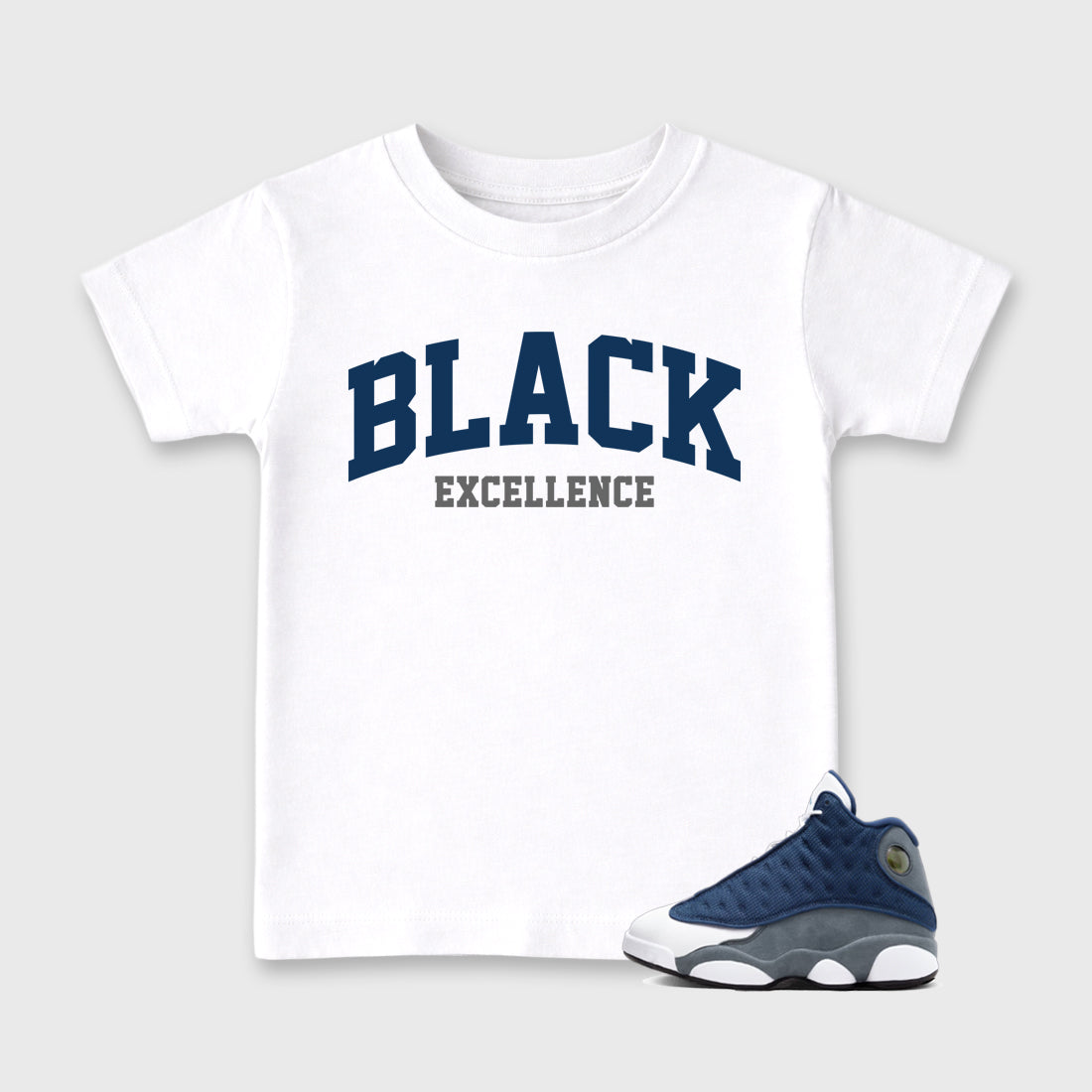 Varsity Black Excellence Baby & Kids Graphic T-Shirt featuring original artwork designed to match the Air Jordan 13 Flint. White 1 Kids Graphic Tee.