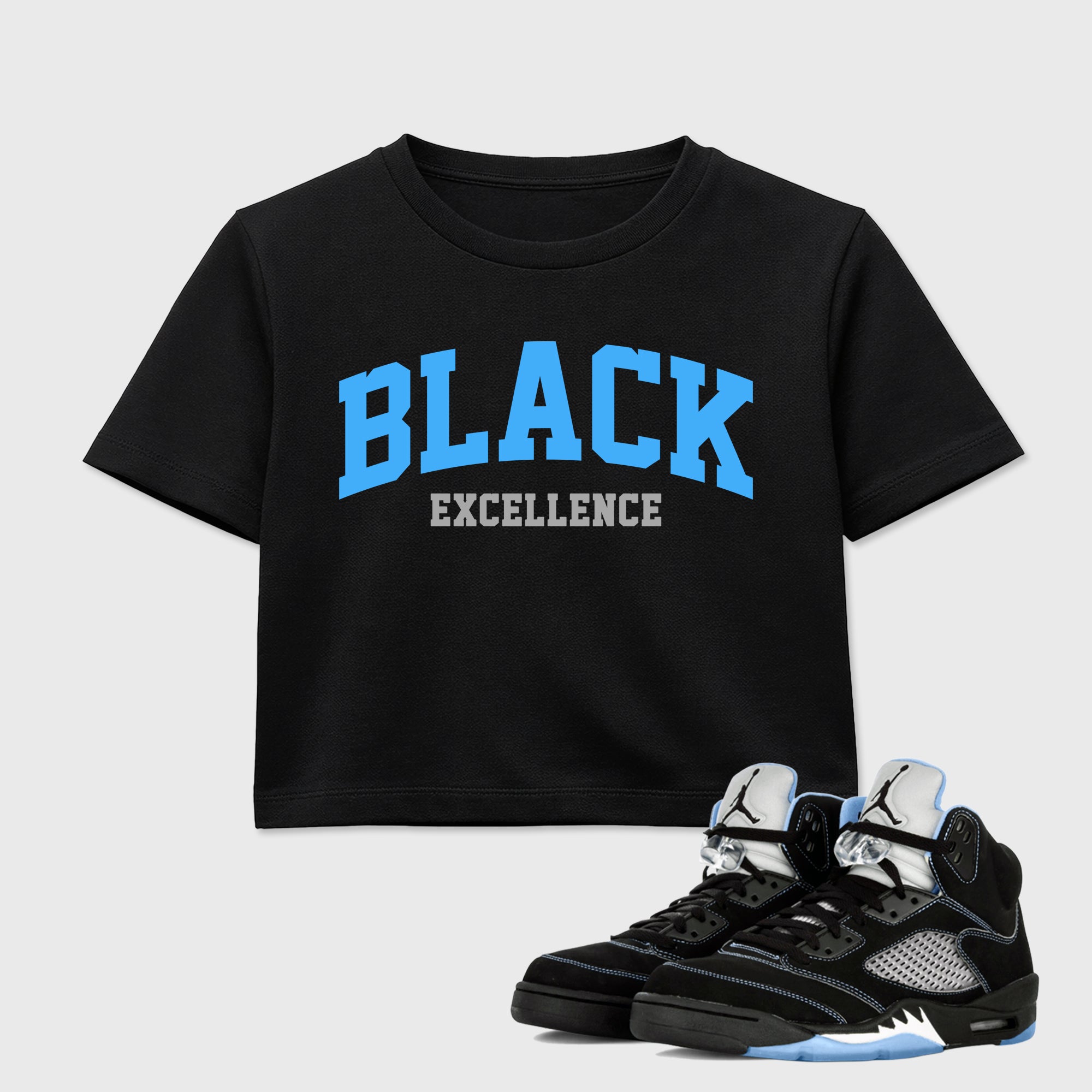 Varsity Black Excellence women’s crop tee designed to match the Air Jordan 5 Black Carolina, featuring coordinated Black 1 options for a perfect streetwear vibe.