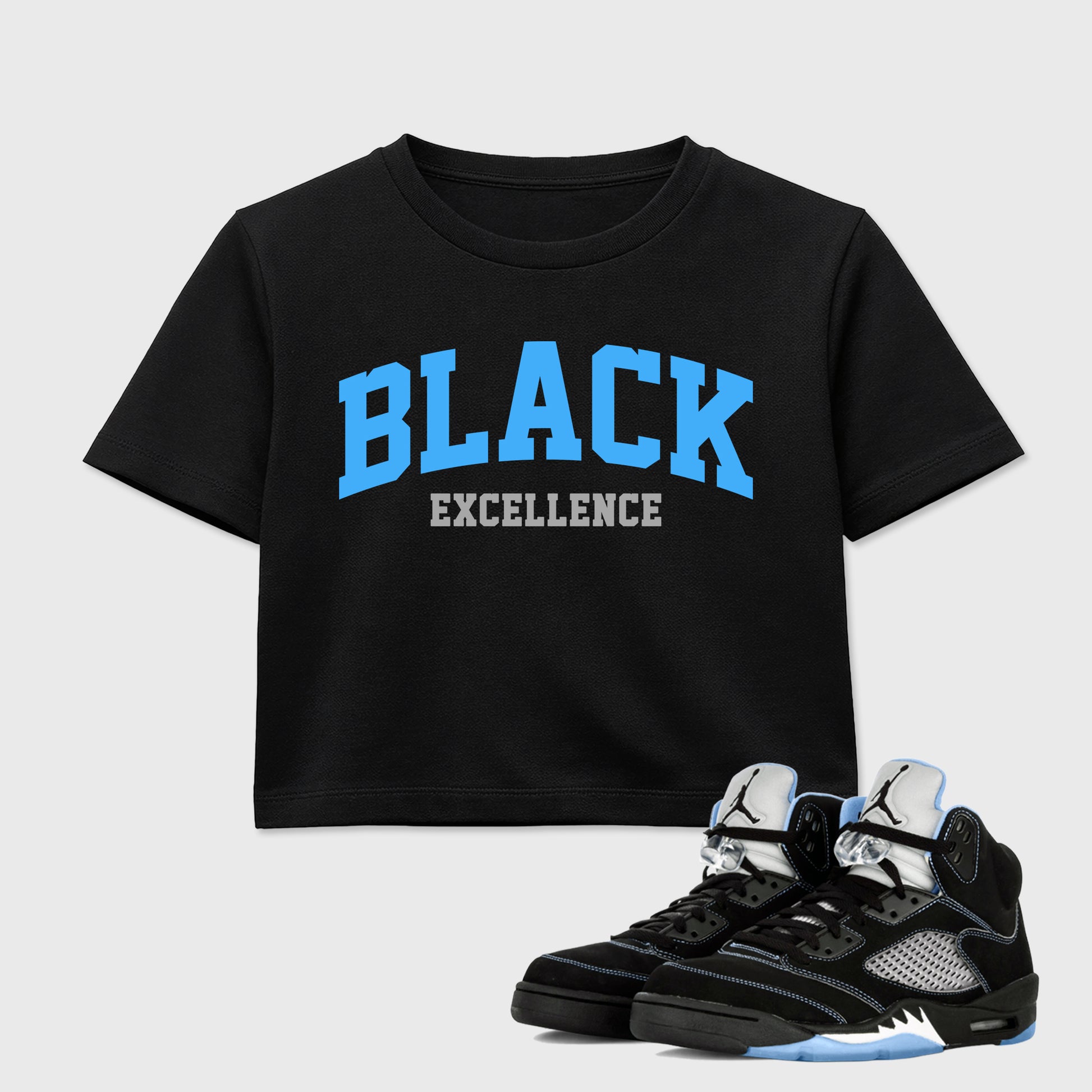 Varsity Black Excellence women’s crop tee designed to match the Air Jordan 5 Black University Blue, featuring coordinated Black 1 options for a perfect streetwear vibe.