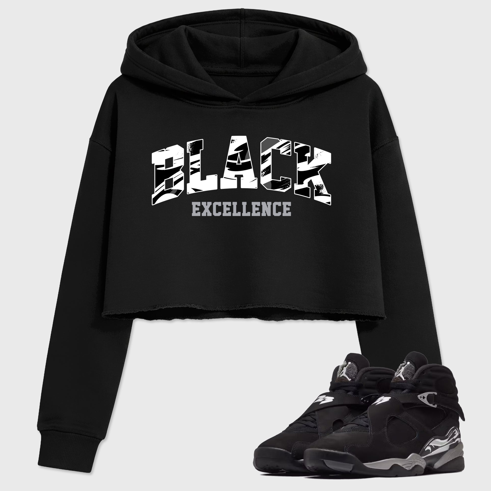 Varsity Black Excellence Women’s Graphic Crop Tee featuring original streetwear artwork designed to match the Air Jordan 8 Chrome. Black 1 Crop Tee.