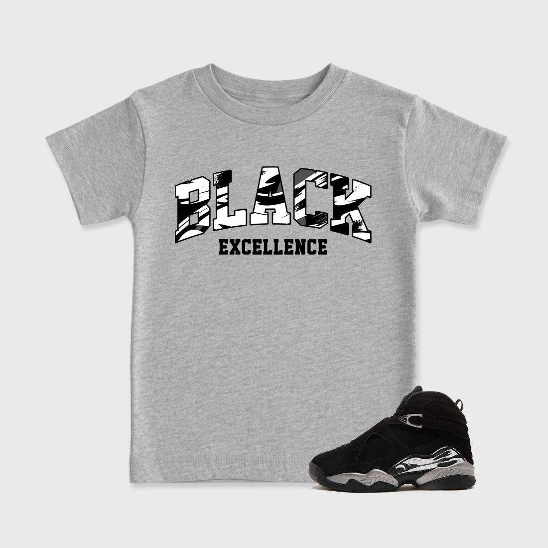 Varsity Black Excellence Baby & Kids Graphic T-Shirt featuring original artwork designed to match the Air Jordan 8 Chrome. Heather Grey 1 Kids Graphic Tee.