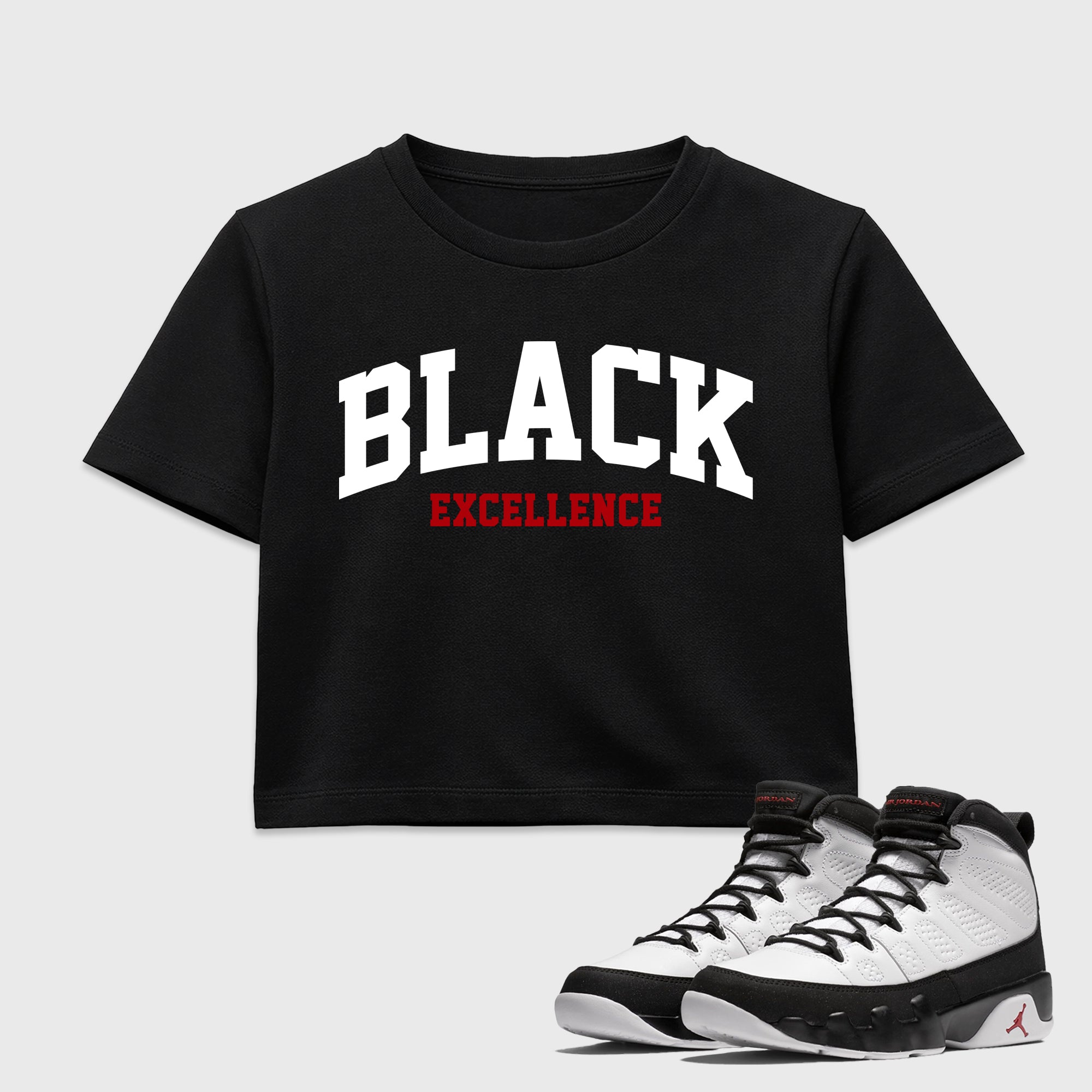 Varsity Black Excellence women’s crop tee designed to match the Air Jordan 9 True Red, featuring coordinated Black 1 options for a perfect streetwear vibe.