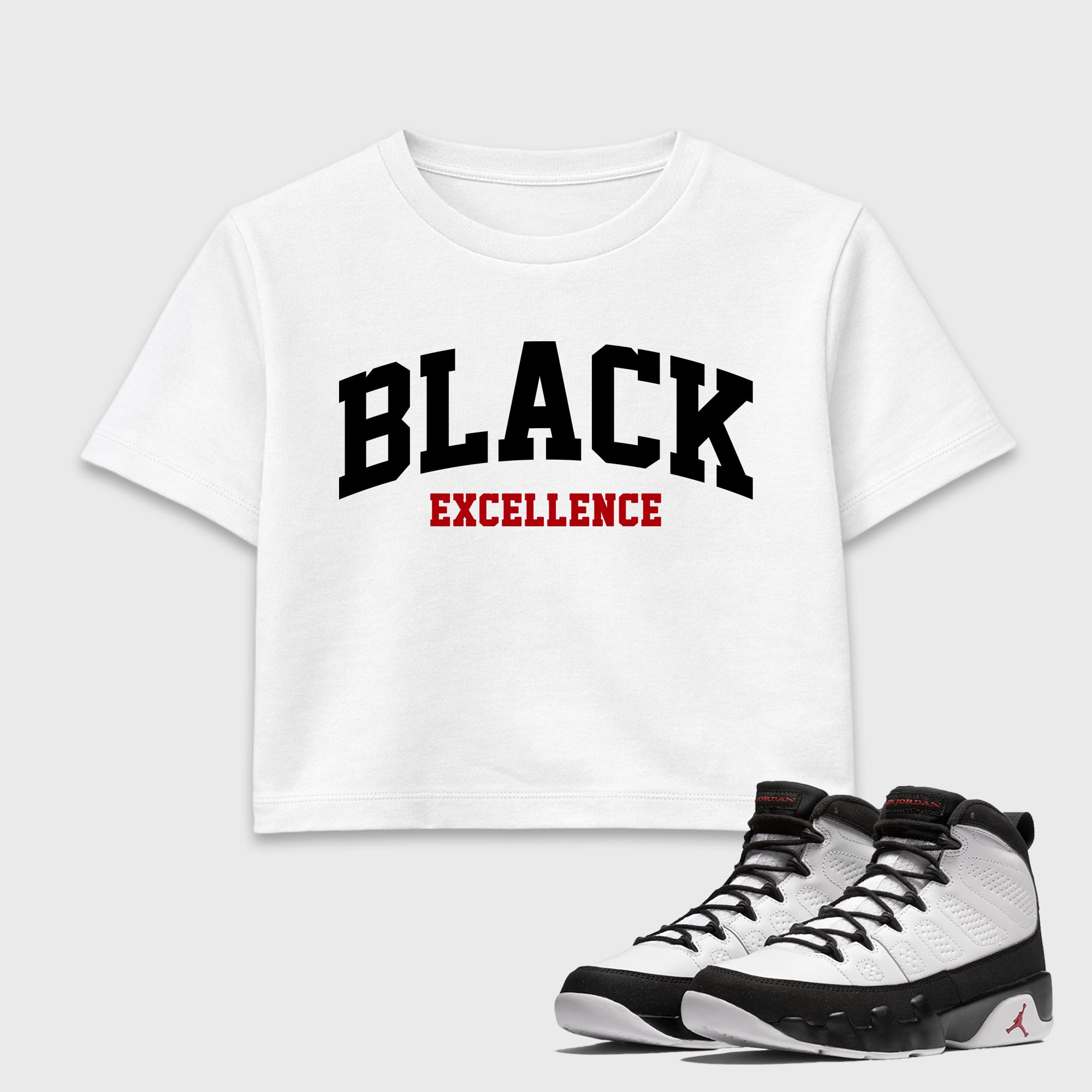 Varsity Black Excellence women’s crop tee designed to match the Air Jordan 9 True Red, featuring coordinated White 1 options for a perfect streetwear vibe.