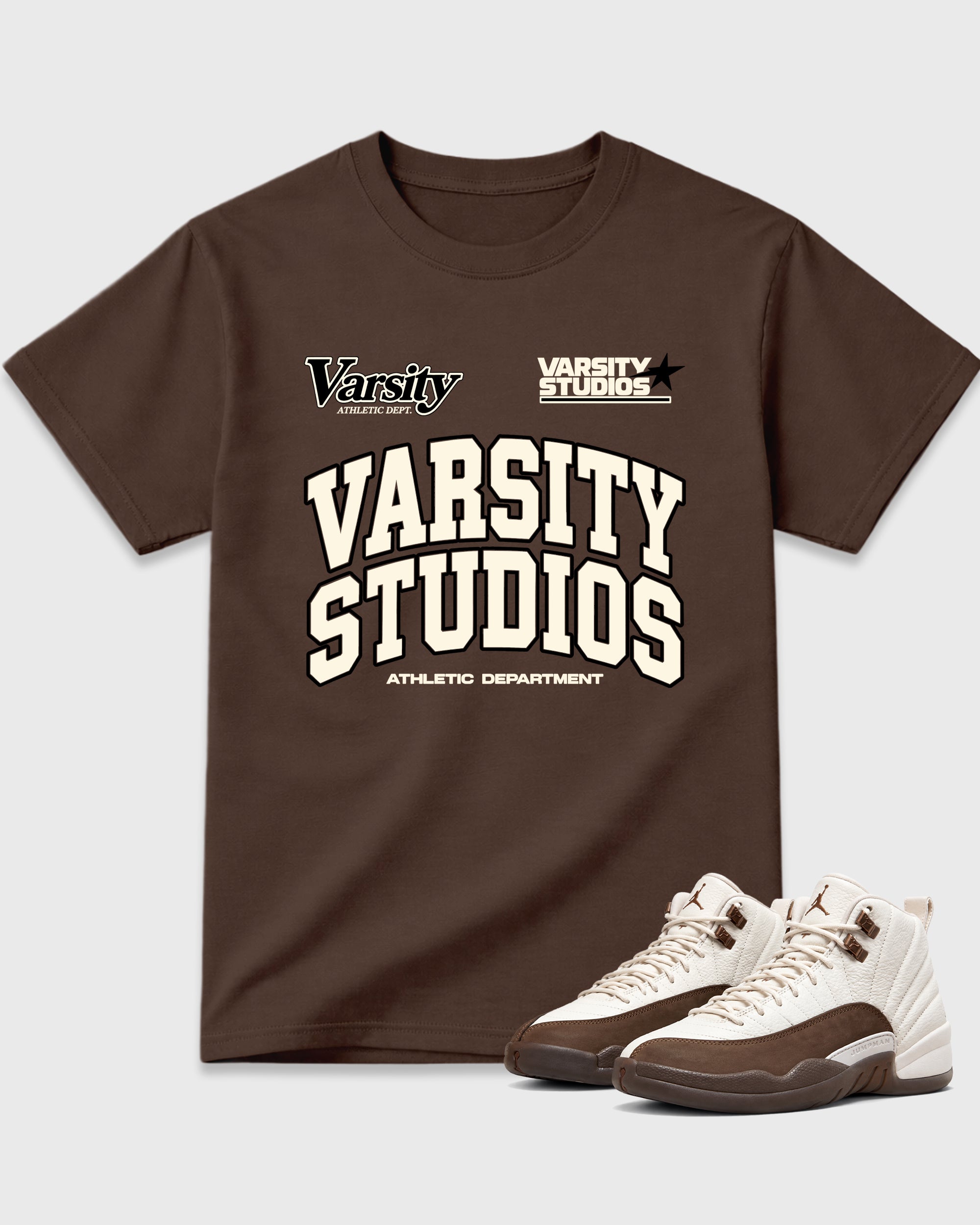 Varsity Studios Graphic T-Shirt featuring original streetwear artwork designed to match the Air Jordan 12 Fireside. Dark Chocolate 1 Graphic T-Shirt.