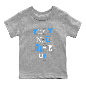Vintage They Not Like Us baby and kids t-shirt crafted for little sneakerheads to shine with the Air Jordan 12 White and University Blue sneakers, displayed in Heather Grey 2.