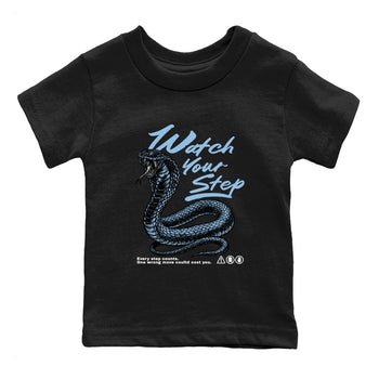 Watch Your Step baby and kids t-shirt crafted for little sneakerheads to shine with the Air Foamposite One Psychic Blue sneakers, displayed in Black 2.