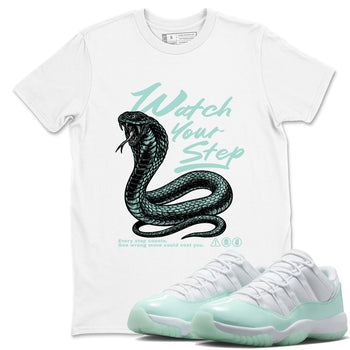 Watch Your Step sneaker match t-shirt styled to complete your fit with the Air Jordan 11 Igloo sneakers, shown in White 1.