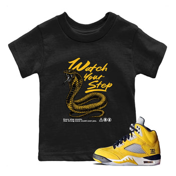 Watch Your Step baby and kids t-shirt crafted for little sneakerheads to with the Air Jordan 5 Tokyo sneakers, displayed in Black 1.